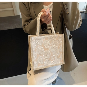 Detail of floral embossed linen tote bag with sturdy rope handles for women