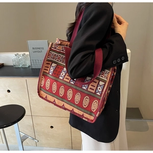 Detail of vintage bohemian tote bag featuring intricate woven geometric patterns and handles