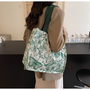 Detail of canvas tote bag featuring vintage green floral print and sturdy shoulder strap