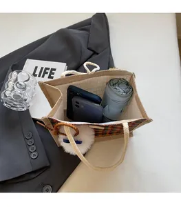Spacious interior of jute tote bag showing capacity for folding umbrella and smartphones