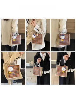 Linen bento tote bag with houndstooth pattern and duck charm on a model outfit