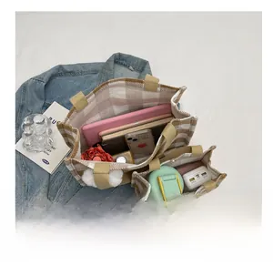 Detailed interior storage view of two-piece plaid tote bags showing high capacity