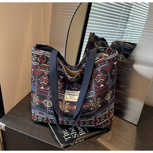 Detail of colorful geometric ethnic canvas tote bag showing textured weave and top handle