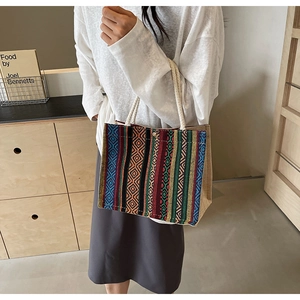 Detailed texture of multi-color geometric ethnic woven tote bag with cotton rope handles