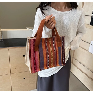 Close-up of ethnic striped tote with bohemian geometric patterns and canvas handle