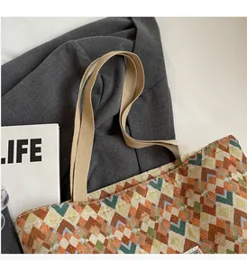 Detail of bohemian tote bag showing woven geometric pattern and durable textile handles
