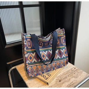 Close-up of geometric ethnic woven tote bag featuring colorful cotton-linen patterns