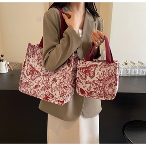 Detail view of two-piece set canvas tote bags with vintage red butterfly and floral prints