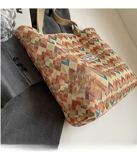 Detailed view of woven fabric tote bag with colorful geometric patterns and handles
