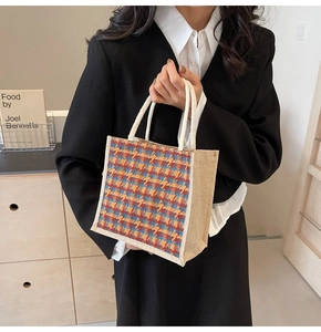Detail of a plaid linen tote bag with colorful woven patterns and rope handles