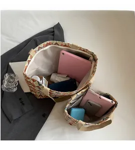 Detail view of canvas tote bag interior showing iPad, phone, and umbrella capacity