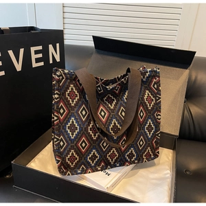 Macro detail of geometric jacquard tote bag in a luxury gift box with premium texture