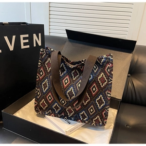 Close-up of vintage tote bag featuring colorful geometric patterns in a premium gift box