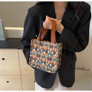 Close-up of bohemian canvas tote bag with vibrant geometric pattern and fabric handle