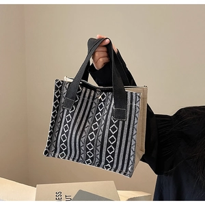 Detail shot of ethnic style tote bag featuring black and white geometric woven patterns