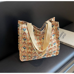Detail of the geometric diamond pattern and thick handles on a bohemian canvas tote bag