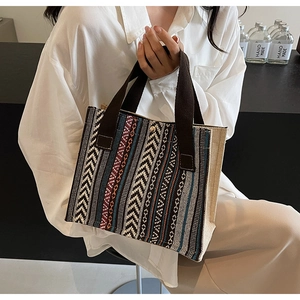 Detail of ethnic style canvas tote bag with bohemian geometric pattern and handles