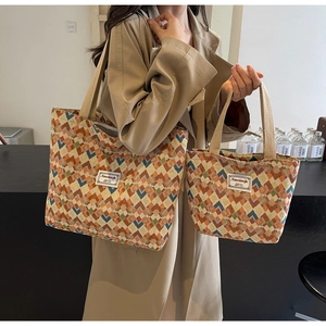 Detail of bohemian tote bag set with colorful geometric patterns and woven handles