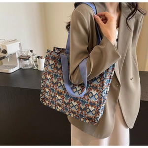 Detail shot of bohemian geometric jacquard tote bag with blue woven handles