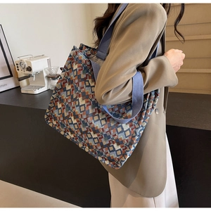 Detailed close-up of colorful jacquard weave texture and geometric patterns on tote bag