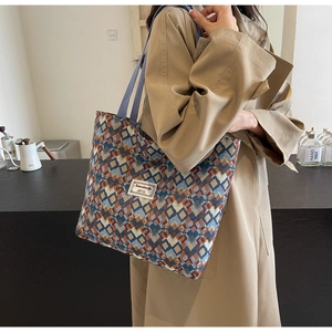 Close-up of bohemian tote bag featuring colorful geometric patterns and fabric brand label