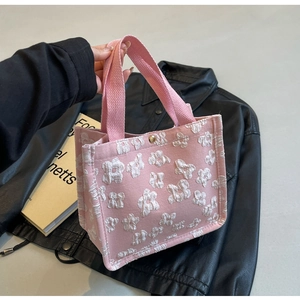 Pink tote bag detail with 3D floral embroidery and gold snap button closure