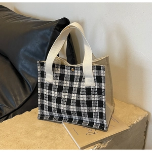 Close-up of woven checkered pattern handbag with premium golden magnetic closure