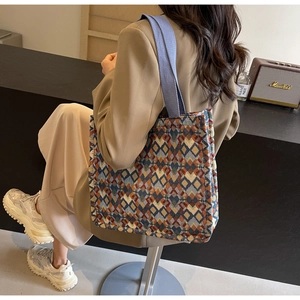 Detail of multi-color geometric rhombus patterned tote bag with durable woven texture