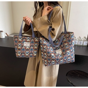 Close-up of geometric patterned canvas tote bags in large and small sizes with jacquard texture