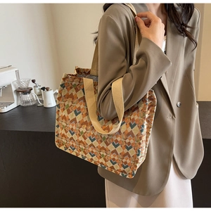Detail of bohemian tote bag showing thick woven geometric pattern and reinforced handles