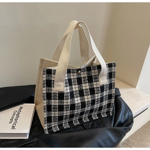 Detail of checkered woven fabric and beige canvas texture on the stylish tote bag