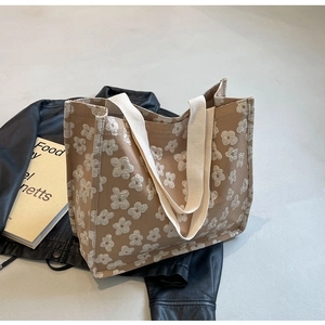 Detail of canvas tote bag with white 3D flower pattern and wide shoulder straps
