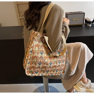 Detail of bohemian tote bag featuring geometric rhombus pattern and wide shoulder strap