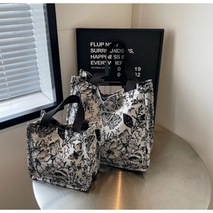 Detail of two-piece floral canvas tote set with black ribbon handles for daily use