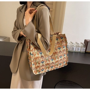Detail of bohemian tote bag showing colorful geometric diamond patterns and wide canvas straps
