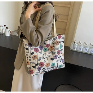Close-up of colorful floral canvas tote bag with textured fabric and durable woven handle