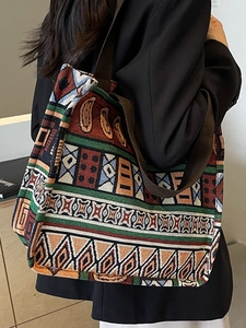 Vintage boho tote bag with colorful geometric patterns and wide canvas strap in side view