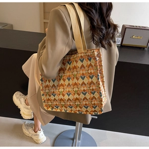 Detail of bohemian tote bag featuring multi-color geometric jacquard and canvas texture