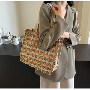 Detail of bohemian tote bag featuring geometric woven patterns and sturdy fabric handles