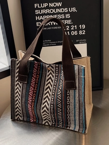 Ethnic woven tote bag with geometric patterns and colorful stripes and top handles