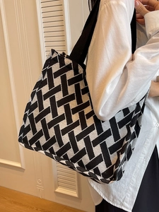 Women's black and white geometric woven tote bag with wide shoulder straps for daily use