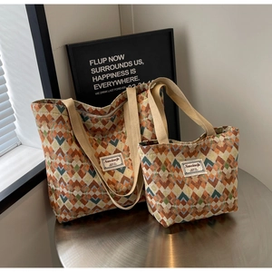Detail of bohemian tote bags with geometric weave pattern in two different sizes