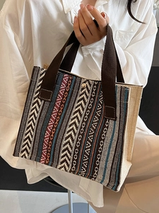 Ethnic style woven canvas tote bag with colorful geometric patterns and gold buckle