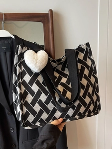 Women's black and white geometric tote bag with heart pendant and wide strap