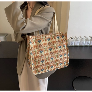 Detail of bohemian tote bag with colorful geometric patterns and beige webbing handles
