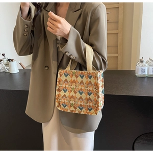 Detail of bohemian tote bag with geometric diamond pattern and thick woven handles