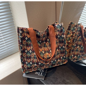 Detail view of woven bohemian tote bag with geometric diamond texture and wide strap