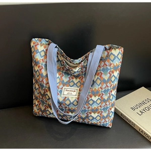 Close-up of geometric diamond pattern canvas tote with Nanxiaojie woven label detail