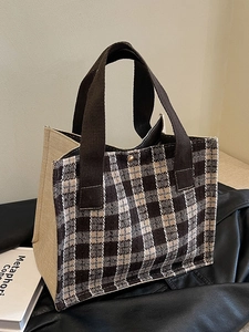 Classic checkered woven tote bag with brown fabric handles and gold snap button closure