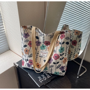 Close-up of knit floral tote bag with mirror reflection showing detailed woven texture